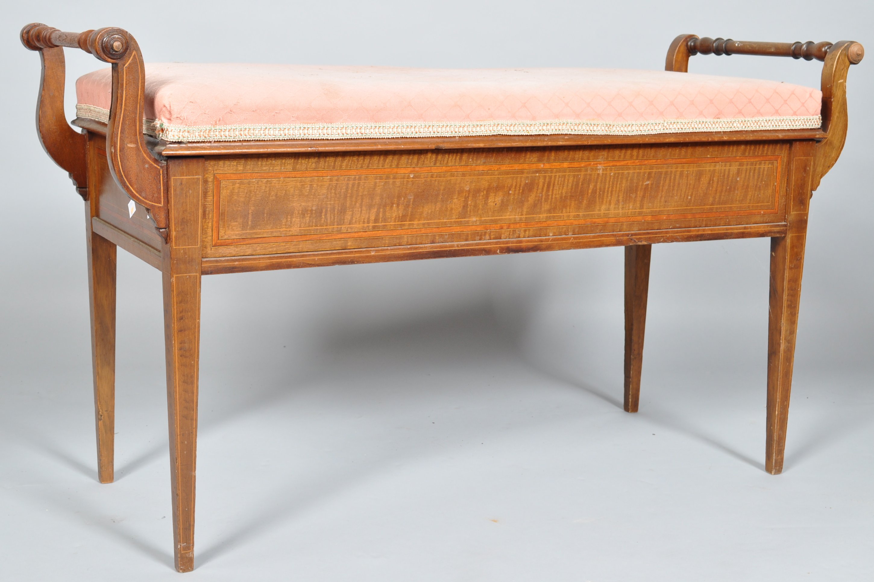 An early 20th century Edwardian inlaid duet stool having scrolled handles to either side,