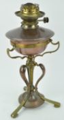 A copper and brass Art Nouveau oil lamp, the adjuster to the copper reservoir,