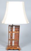 A 20th Century contemporary Chinese teak wood abacus lamp having thirteen rows with beads and being