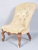 A plain button backed nursing chair on a mahogany framed base with shaped carved decoration,