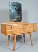 A mid 20th century 1950's retro vintage golden oak dressing table having a shaped frameless mirrror