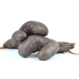 A pair of brown leather boxing gloves,