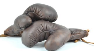 A pair of brown leather boxing gloves,