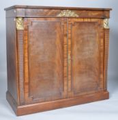 A Regency style mahogany two door side cupboard, with brass mounts,