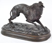 A 20th century bronze figure of a whippet with riding crop in his mouth,