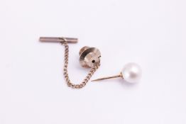 A tie pin set with a 8mm white cultured pearl together with a strand of graduated simulated pearls