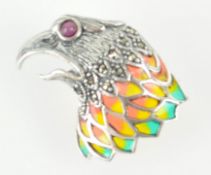 A white metal eagle head brooch/pendant set with marcasite and a cabochon cut ruby eye and finished