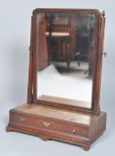 A 19th century mahogany swing mirror having shaped glass supports and acorn finials,