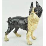 A cast iron figure of a French bulldog, painted black and white,