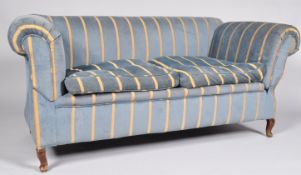 A drop end two seater sofa, of traditional rolled arm and back design, upholstered in blue and gold,