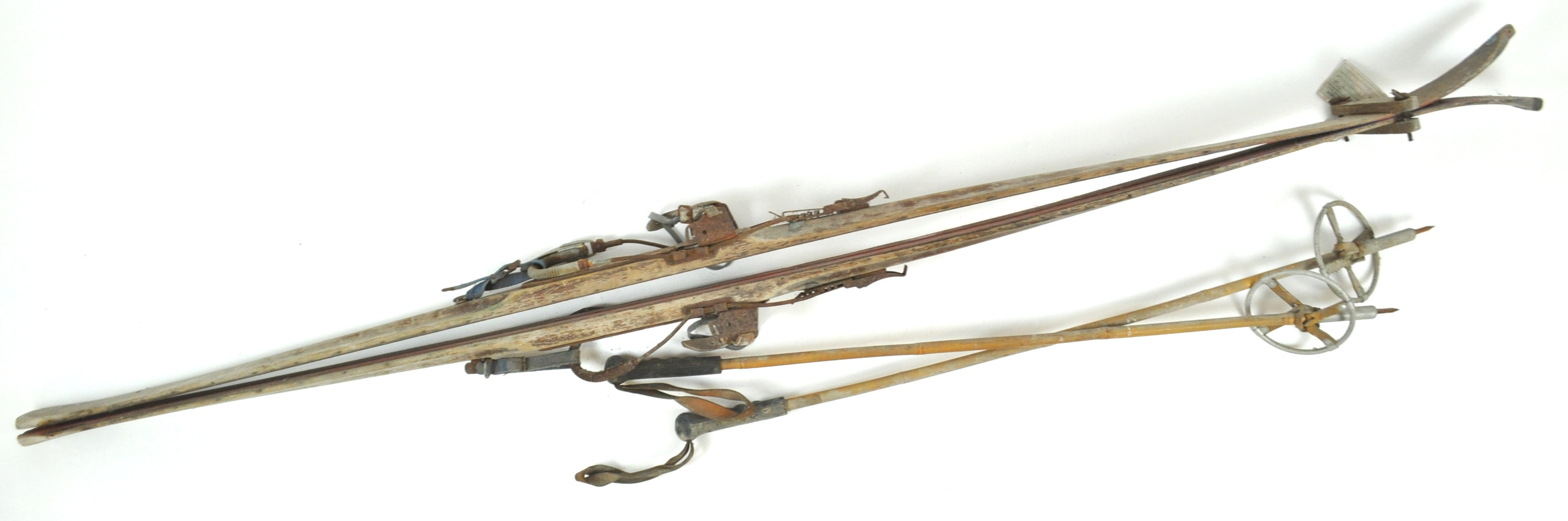 A pair of 1940's skis and later poles