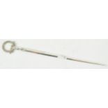 A silver game skewer/letter opener, the handle in the form of a ribbon tied laurel wreath,