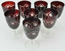 A set of eight Bohemian ruby flash and cut glass wine glasses,