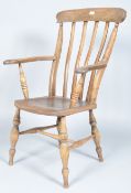 A late 19th century Victorian antique elm stick back elbow chair/armchair having the tall stick