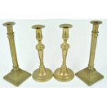 A pair of late 18th century brass candlesticks, of tapering cylindrical form with flared bases,