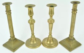 A pair of late 18th century brass candlesticks, of tapering cylindrical form with flared bases,