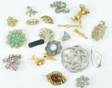 A collection of twenty costume brooches,