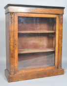 A Victorian walnut and marquetry pier cabinet with gilt metal mounts and glazed door,