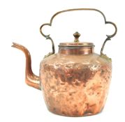 A 19th century large copper kettle with strap handle,