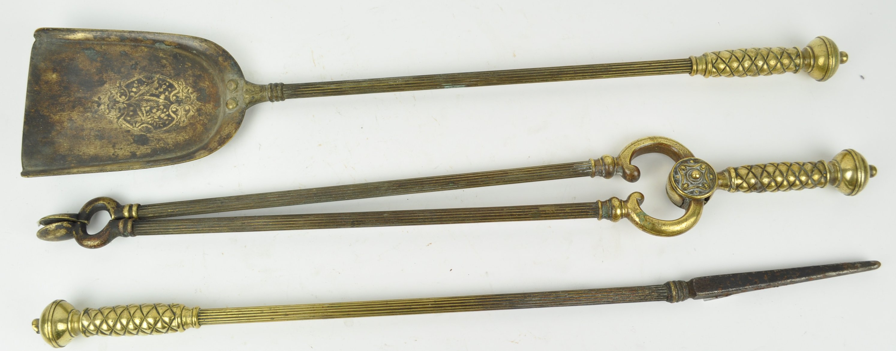 A 19th century brass set of three fire irons, each with ball shaped knops,