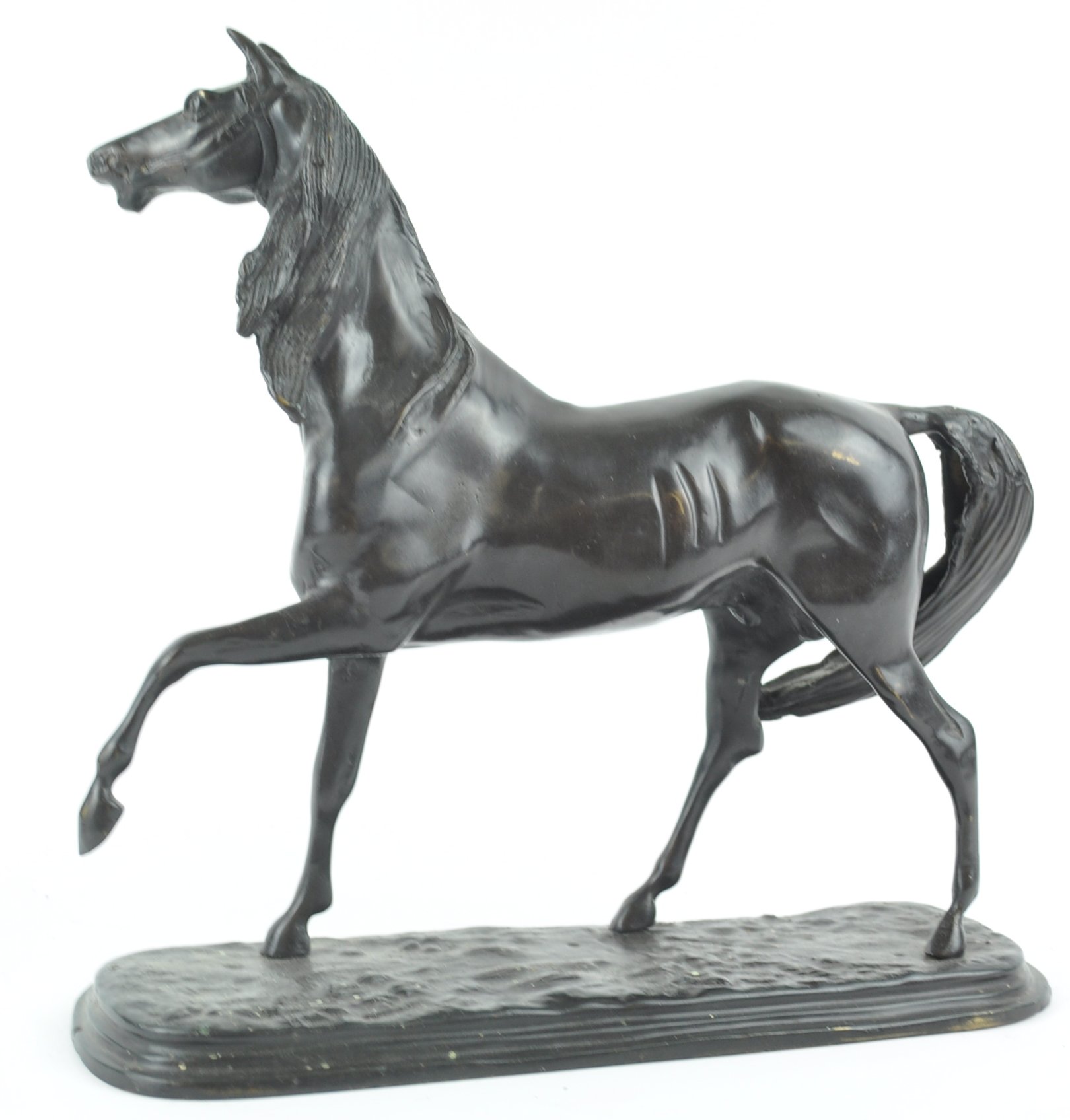 A bronze horse in naturalistic pose, holding a front leg aloft,