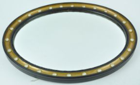 An oval wall mirror with black and gilt frame with simulated crystal drops, 82cm x 41.