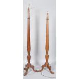 A pair of mahogany standard lamps, carved in the 18th century style with ribbing and fluting,