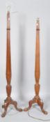 A pair of mahogany standard lamps, carved in the 18th century style with ribbing and fluting,