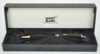 A boxed Mont Blanc ballpoint pen, in black and gilt with original box,