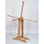 A wood wool winder, of traditional four arm form,