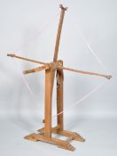 A wood wool winder, of traditional four arm form,