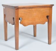 A late 18th Century George III mahogany commode having a shaped frieze and raised on squared legs,