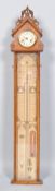 A Victorian oak cased Admiral Fitzroys barometer, with clock face above the printed paper scale,