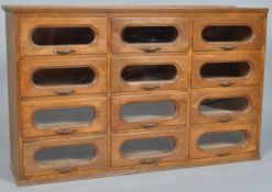 An early 20th century antique vintage oak twelve drawer haberdashery counter top cabinet,
