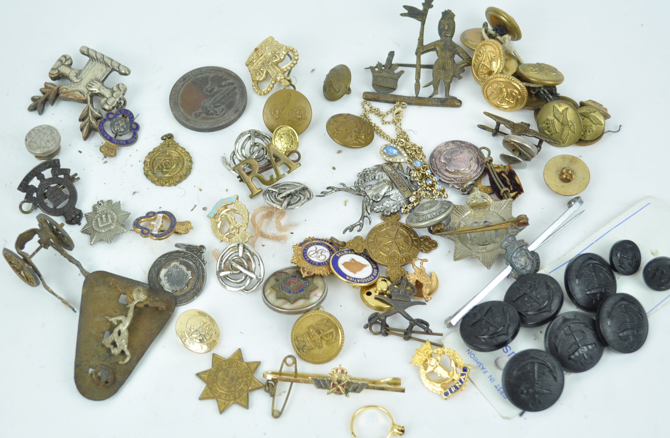 A collection of military buttons and badges, together with fobs,