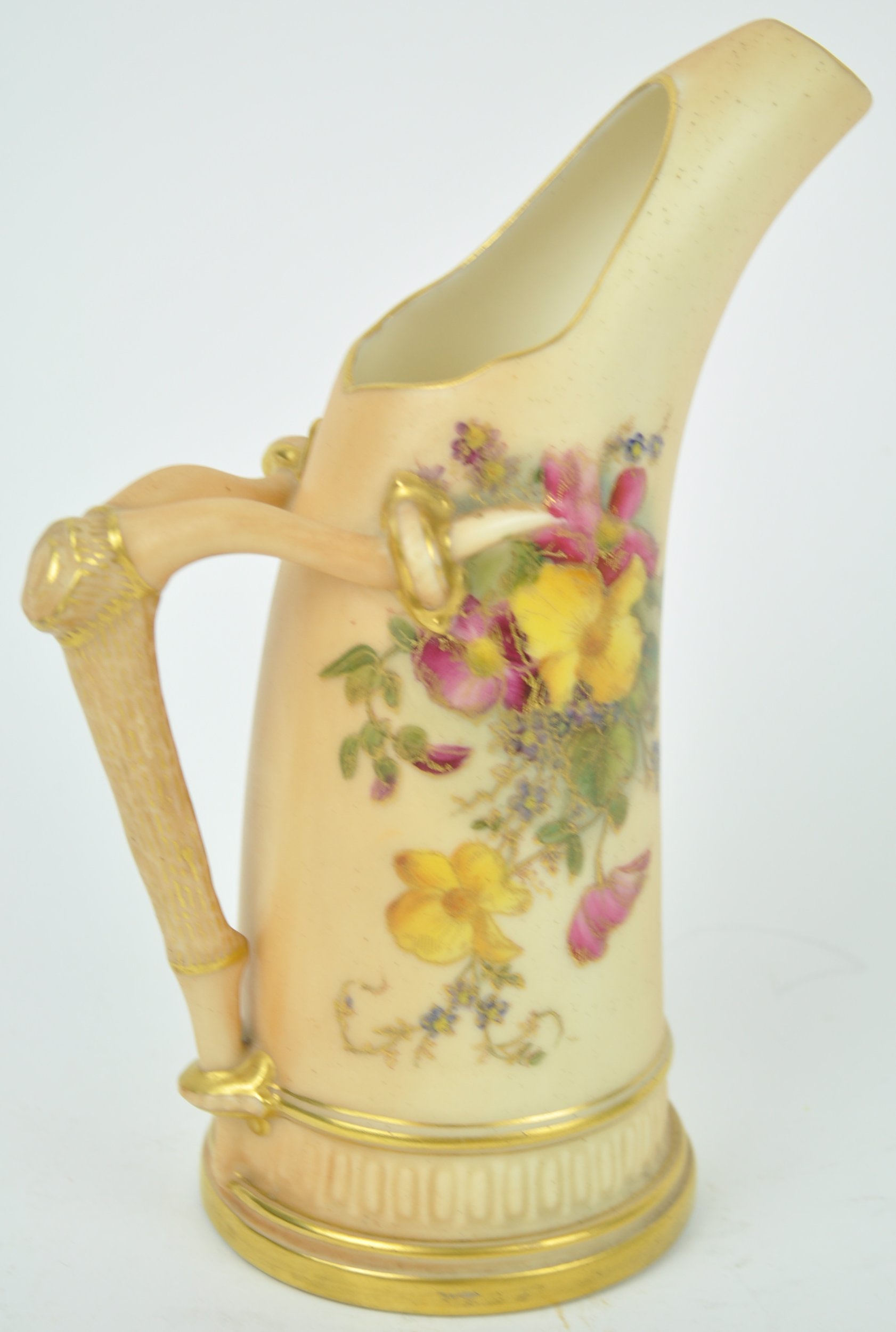 A Royal Worcester blush ivory Tusu style jug, decorated with a floral spray,