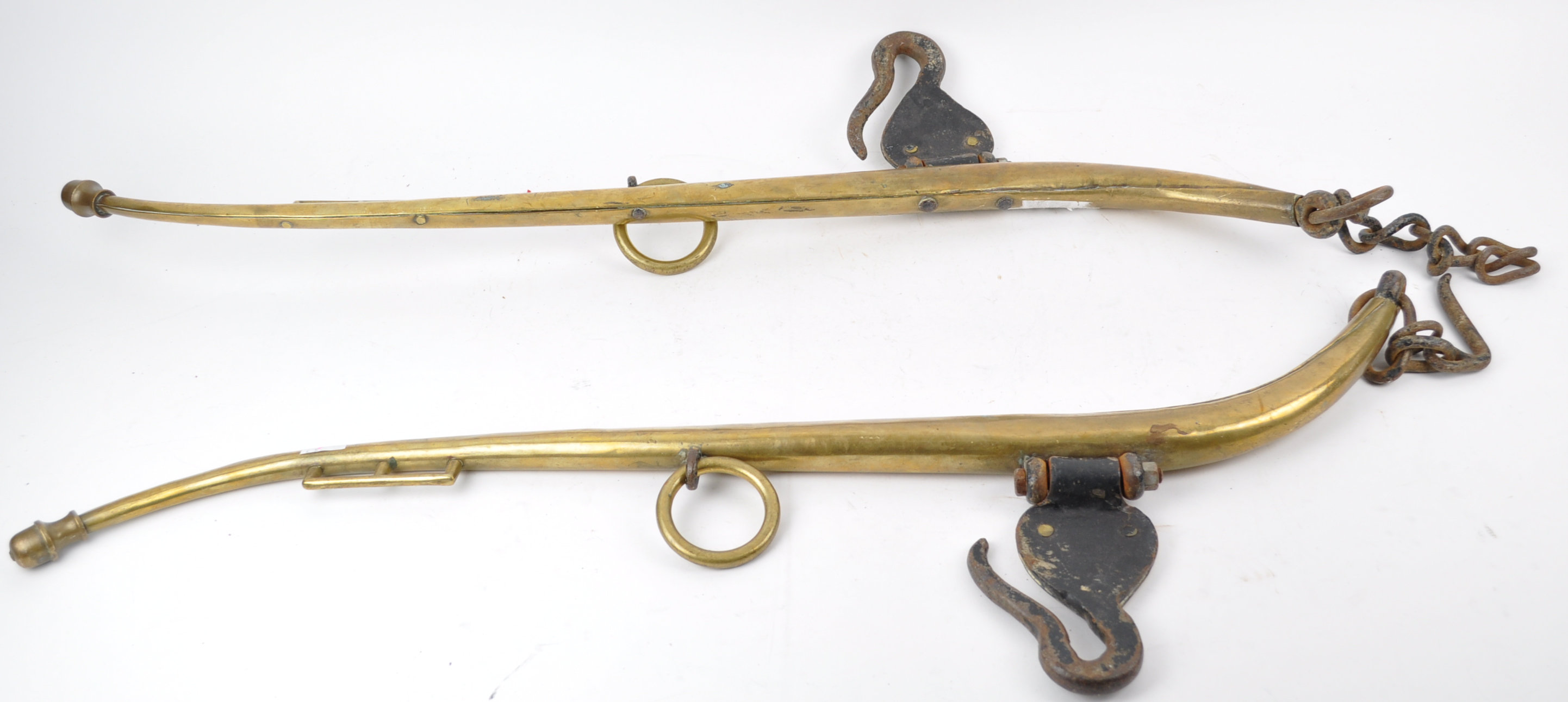 A pair of brass and cast iron horse hames, stamped 'Patent double cased solid brass No 2',