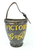 A composite form fire bucket, finished in black and marked Victory G III R,