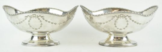 A pair of silver and neo classical style shaped oval bowls with rope work style undulating edges,