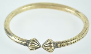 An eastern brass anklet or Kara with ornamentation,