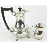 A silver coffee pot, of plain rounded baluster form, with domed cover, raised on four cabriole feet,