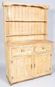 A Late 20th Century Victorian scrubbed pine country dresser having a dresser /plate rack top above