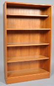 A 20th century retro vintage teak wood bookcase, having four shelves, all raised on a plinth base,
