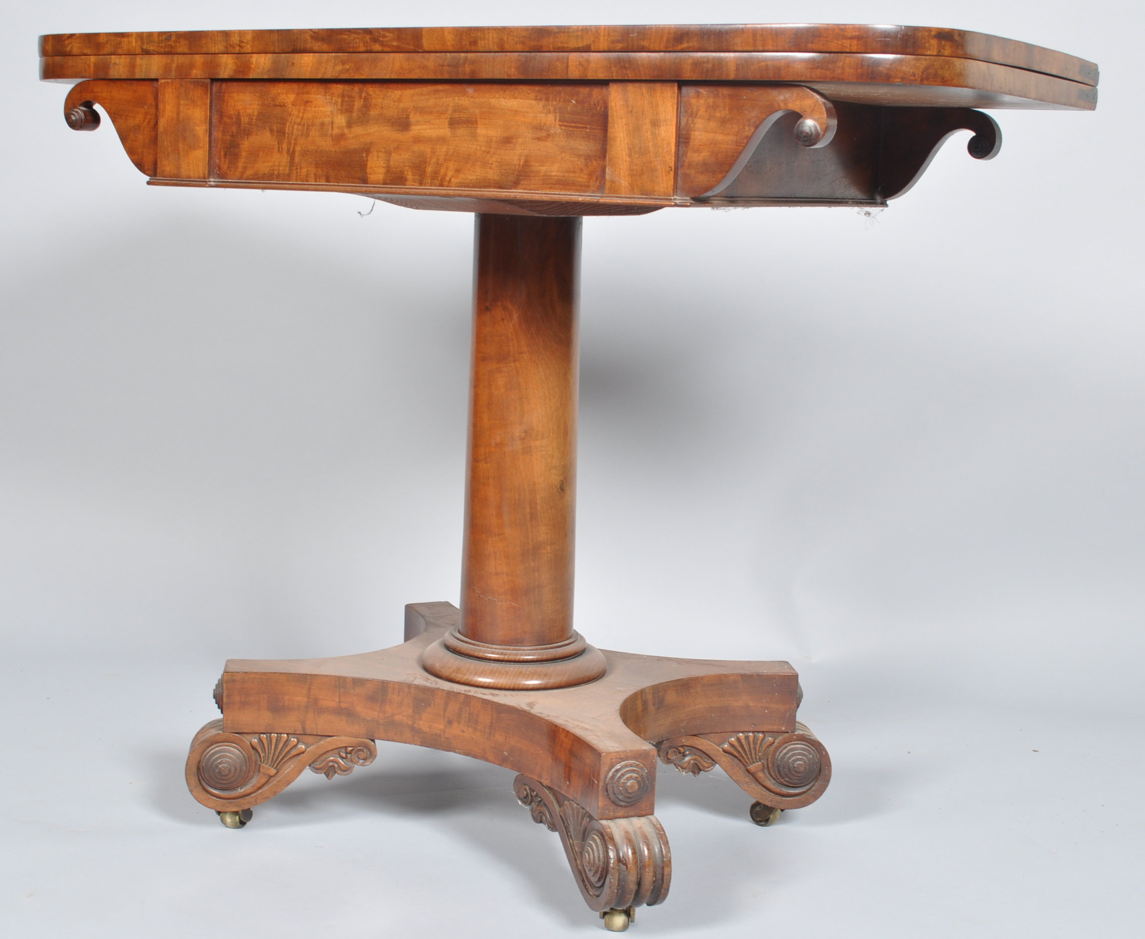 A William IV mahogany card table with cylindrical pedestal on waisted rectangular base,