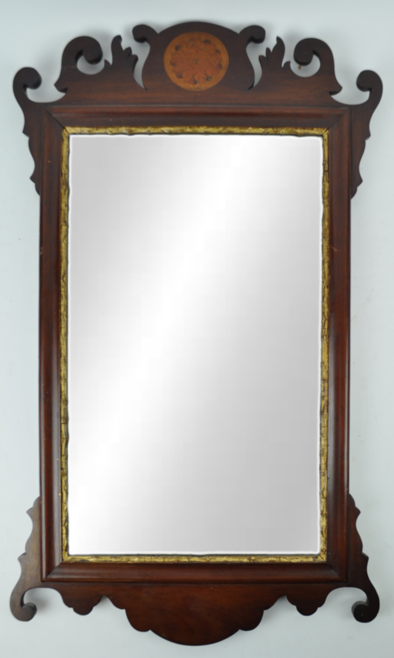 A mahogany fret framed wall mirror with marquetry crest,