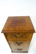 A George III mahogany cross banded side cupboard with three faux drawers