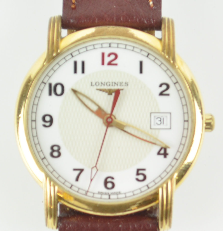 A gold plated Longines quartz wristwatch. Circular dial with numerical markings and date feature.