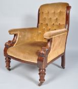 A button back armchair with shaped mahogany side rails over stuffed arms with curved fronts,