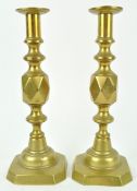 A pair of 'King of diamonds' brass candlesticks, stamped marks,