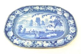 A 19th century pottery meat plate, printed in blue, with farmers in a field with sheep,